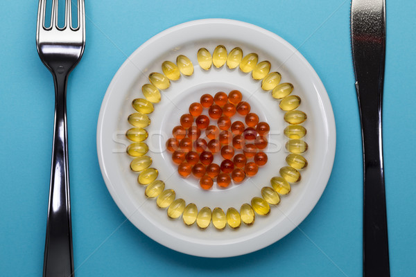 Yellow and red pills on a plate Stock photo © ironstealth