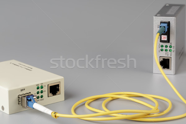 Two media converters connected by cable optical fiber Stock photo © ironstealth