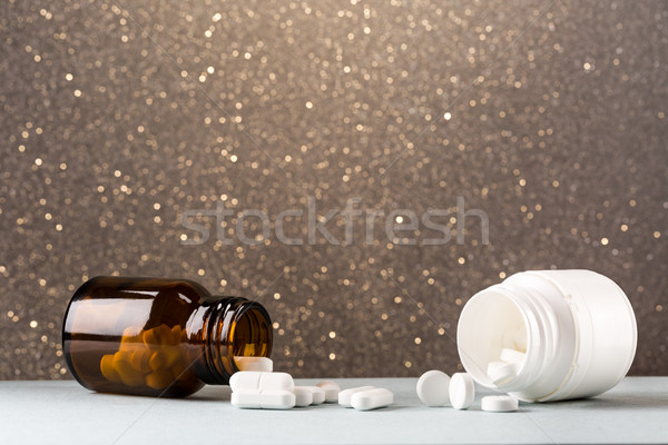 Varius pills bottles and heap of white pill Stock photo © ironstealth