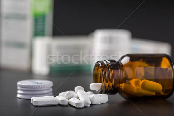 White pills and brown glass pill bottle Stock photo © ironstealth