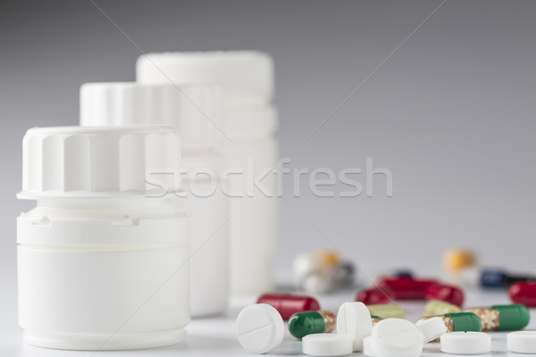 White medicine bottle and various colorful pills Stock photo © ironstealth