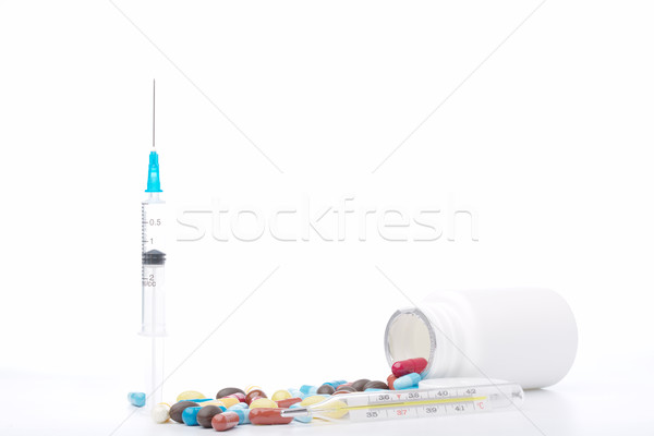 Syringe, pills bottle, thermometer and capsules on white background Stock photo © ironstealth