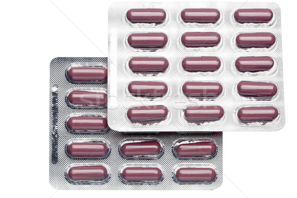 Brown capsules in a foil blister pack isolated on white background Stock photo © ironstealth