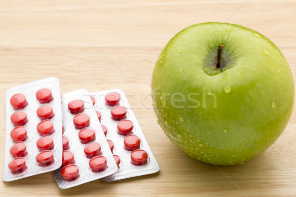 Red pills blister pack and green apple Stock photo © ironstealth