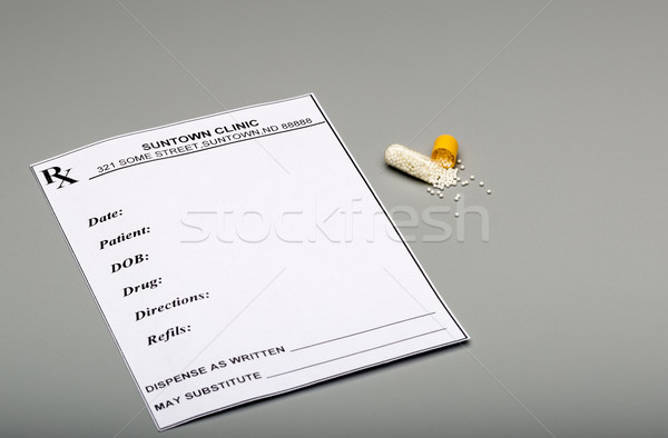 Prescription and open capsules with micro granules Stock photo © ironstealth