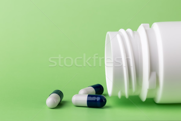Blue pills and a bottle of medicine Stock photo © ironstealth