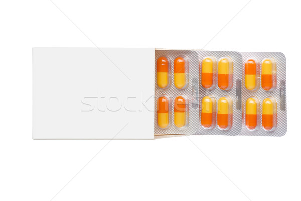 Grey box with orange pills in a blister pack Stock photo © ironstealth