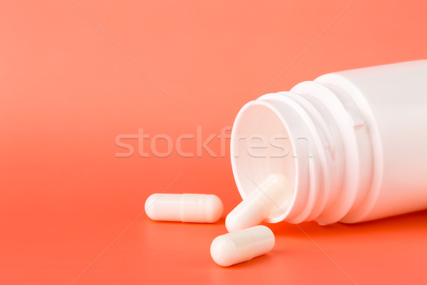 White pills and open medicine bottle Stock photo © ironstealth