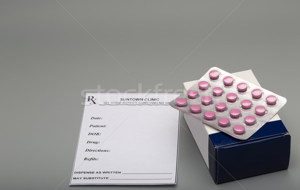Stock photo: Prescription red pills and blue pill box