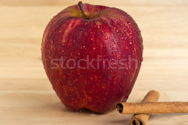 Fresh ripe red apple and cinnamon sticks on wooden background Stock photo © ironstealth