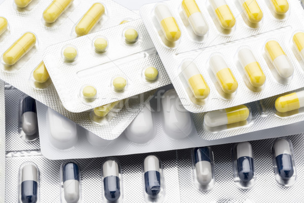 Stock photo: Lot pill packs of colorful tablets and capsules