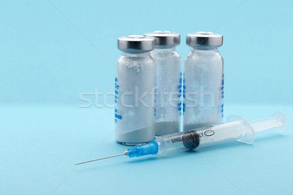 Healthcare and medicine,syringe, medicine bottle on blue background Stock photo © ironstealth