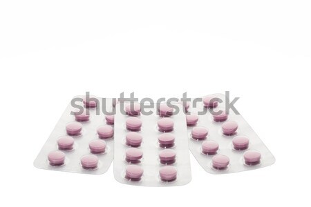 Set of pink pills in a blister pack on white background Stock photo © ironstealth