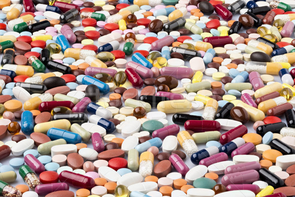 Scattered various colorful medical pills and drugs Stock photo © ironstealth