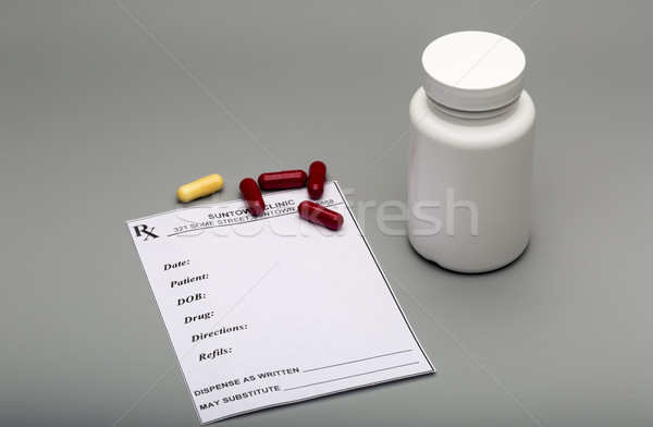 Prescription capsules and pill bottle Stock photo © ironstealth