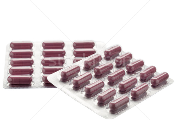 Brown pills foil blister pack Isolated on white background Stock photo © ironstealth