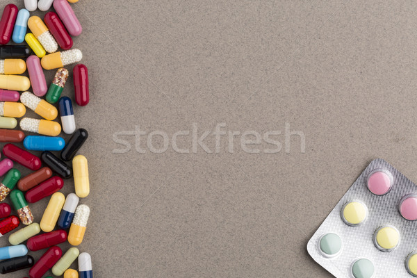 Various colorful capsules and pills on brown craft paper Stock photo © ironstealth