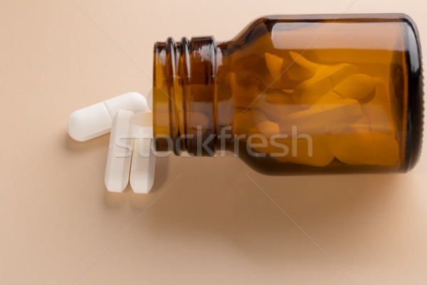 Brown glass pill bottle and white pills Stock photo © ironstealth