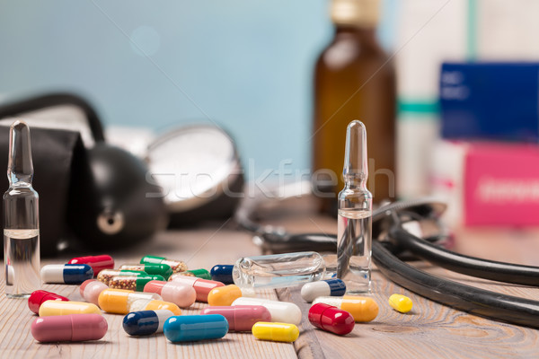 Various colorful capsules and medical equipment Stock photo © ironstealth
