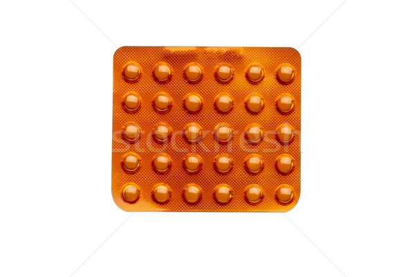 Orange pills in a blister pack isolated on white background Stock photo © ironstealth