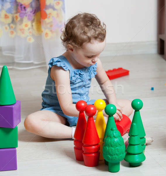 Stock photo: beautiful girl plays toys in room