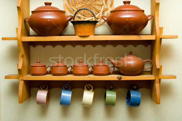 Ceramic utensils on a wooden shelf Stock photo © ISerg