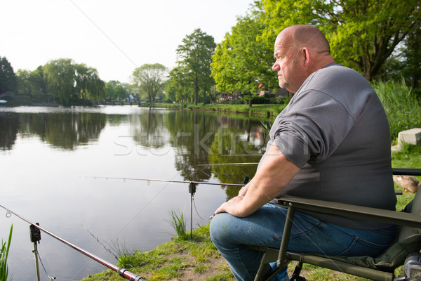 Fisherman with fishing rods Stock photo © ivonnewierink