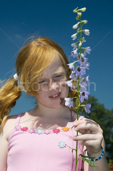 Girl with larkspur flower Stock photo © ivonnewierink