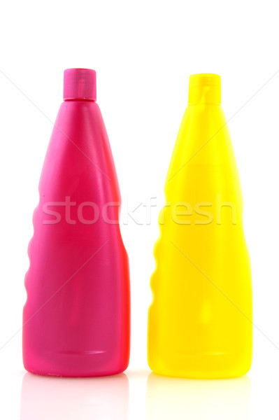 Stock photo: Pink and yellow shampoo bottles