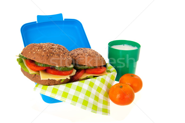healthy brown bread roll in blue lunch box with fruit and milk Stock photo © ivonnewierink
