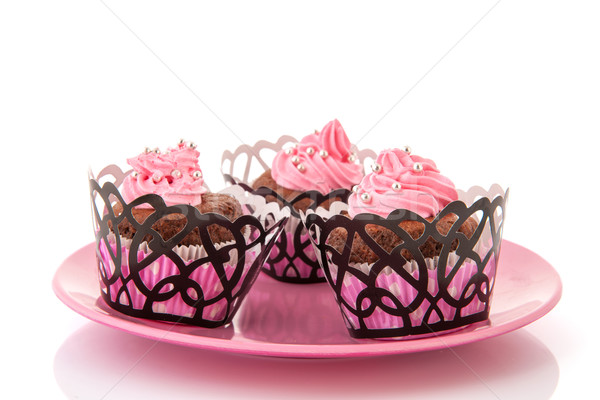 Csokoládé minitorták rózsaszín vajkrém cukorka gyöngyök Stock fotó © ivonnewierink