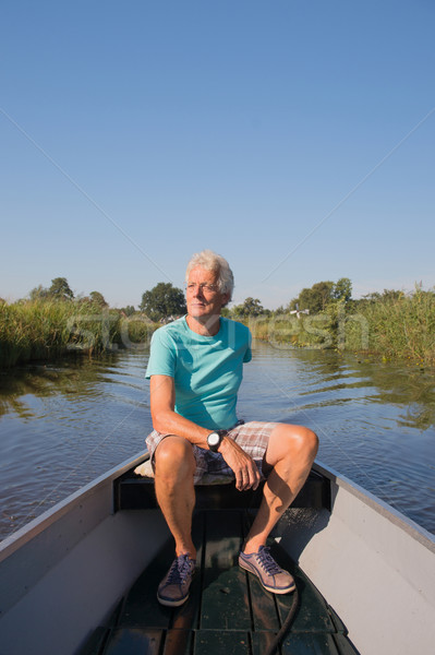 Starszy człowiek motorówka charakter wody lata Zdjęcia stock © ivonnewierink