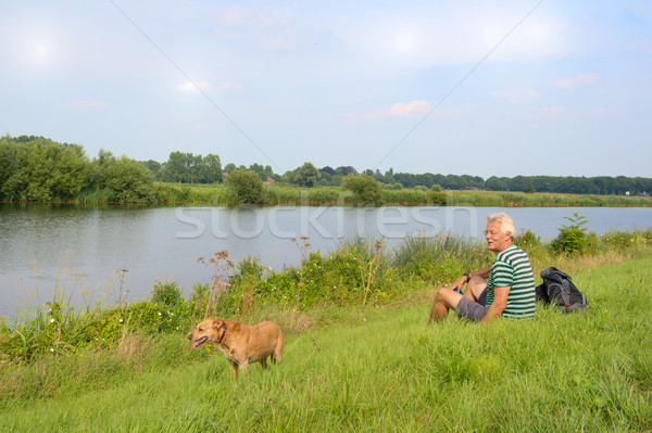 Man with dog near the river Stock photo © ivonnewierink