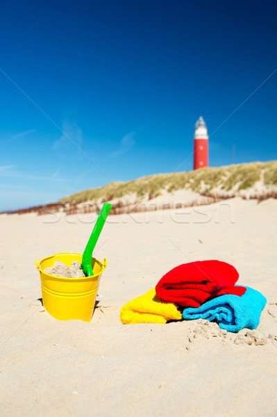 Beach with toys and lighthouse Stock photo © ivonnewierink