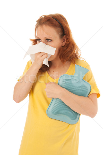 Red haired woman blowing nose with hot water-bottle Stock photo © ivonnewierink