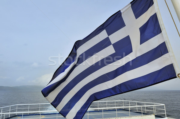 Griechisch Boot hinter Flagge Meer Wolken Stock foto © ivonnewierink