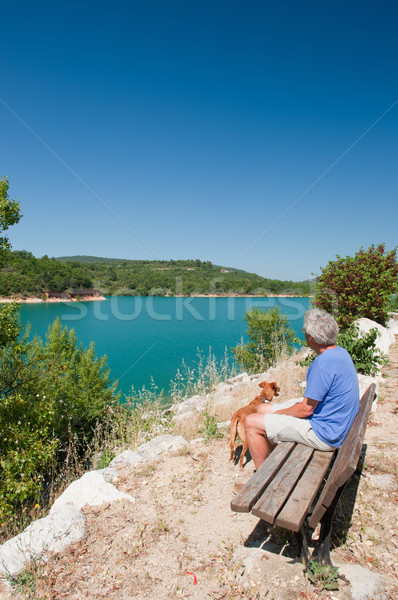 man with dog sitting in French landscape Stock photo © ivonnewierink