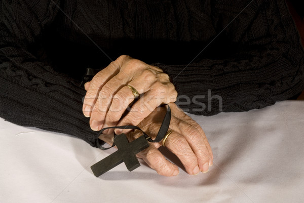Old hands with black cross Stock photo © ivonnewierink