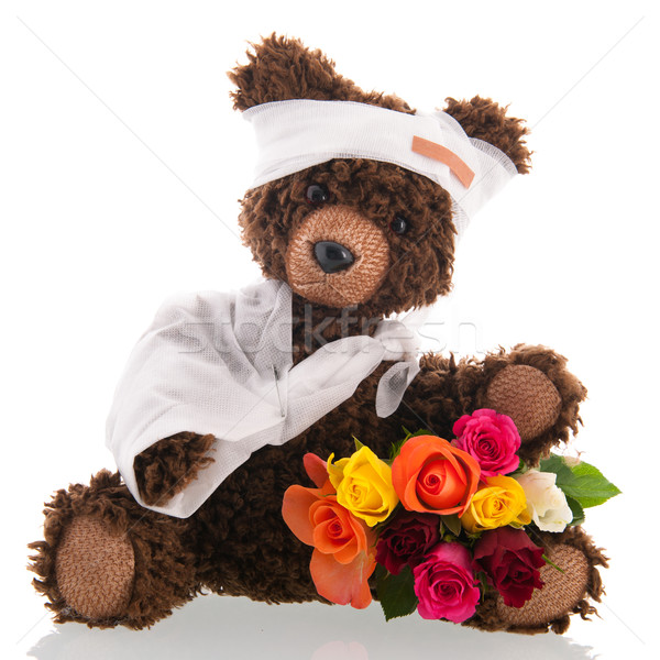 Bear with pain and flowers isolated over white background Stock photo © ivonnewierink
