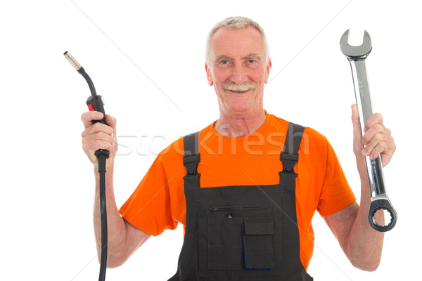 Happy man in orange and gray overall with wrench Stock photo © ivonnewierink
