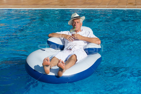 Ricco uomo rilassante proprio piscina viaggio Foto d'archivio © ivonnewierink