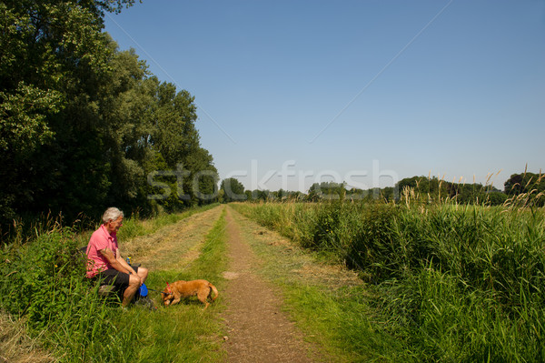 Man with dog in nature Stock photo © ivonnewierink