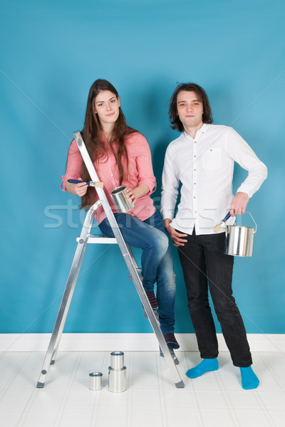 Stock photo: Young couple painting house