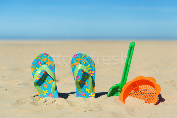 Flip flops and toys at the beach Stock photo © ivonnewierink