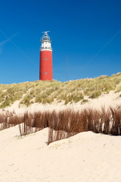 Red lighthouse at the coast Stock photo © ivonnewierink