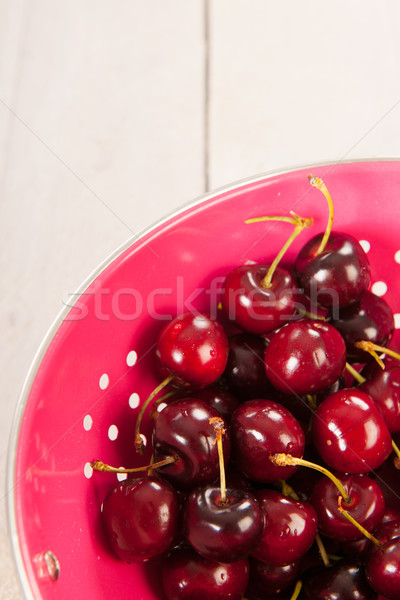Cherries in pink colander Stock photo © ivonnewierink