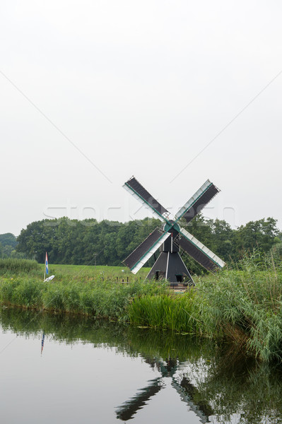 Dutch windmill near the river Stock photo © ivonnewierink