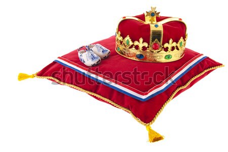 Golden crown on velvet pillow with wooden shoes Stock photo © ivonnewierink
