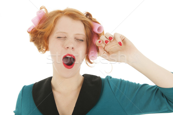 Woman with curlers in hair yawning Stock photo © ivonnewierink