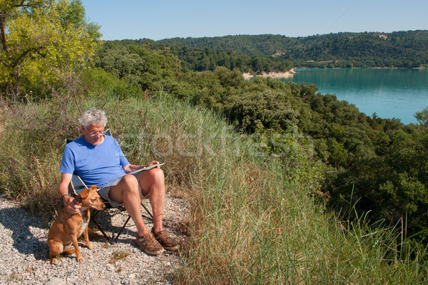 man with dog sitting in French landscape Stock photo © ivonnewierink